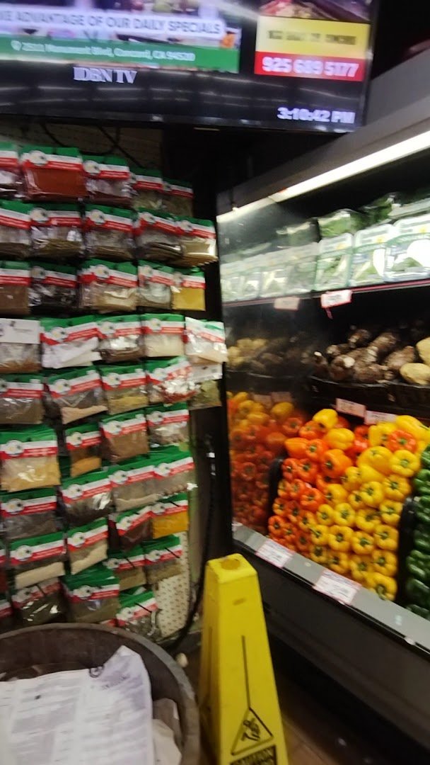 Seafood counter beside colorful produce bins.
